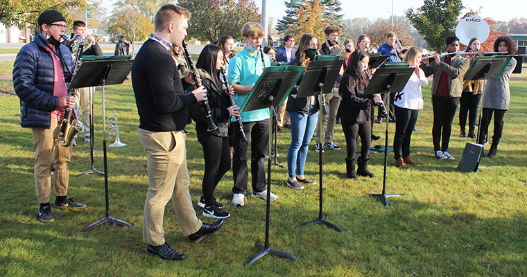 Students perform music outside