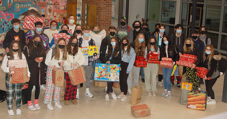 Group photo of students with donation items