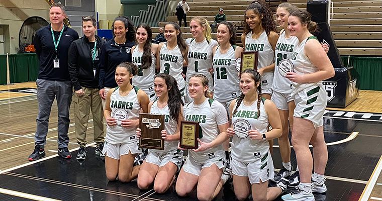 Girls basketball team and coaches pose for group photo