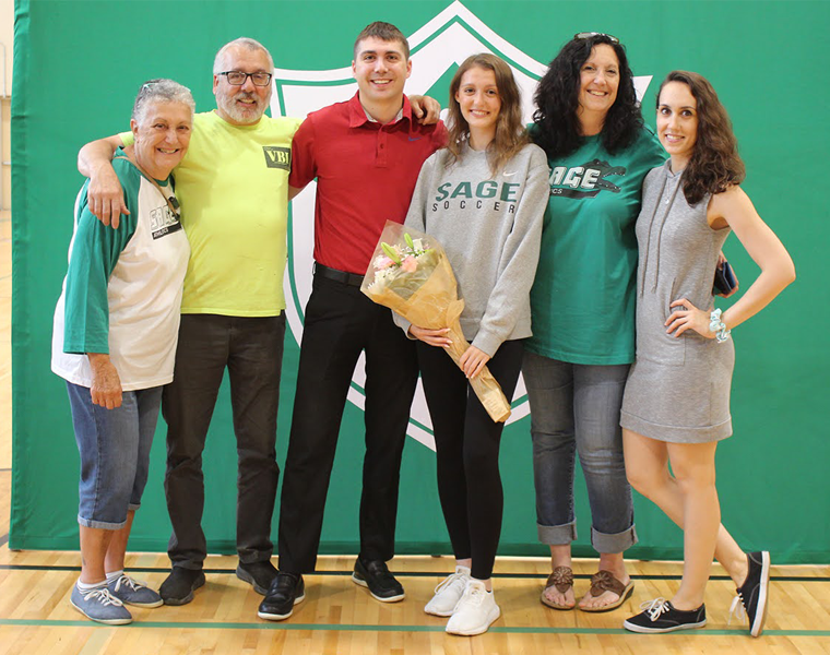 Student posing for group photo with family