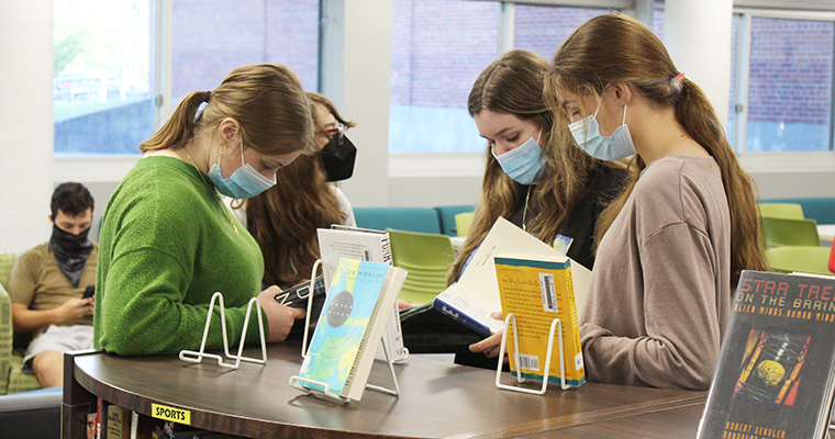 Students masked reading in the library