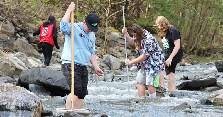 Students wading in the river