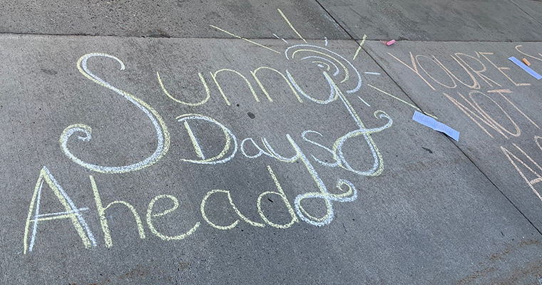 Chalk message that reads "Sunny days ahead"