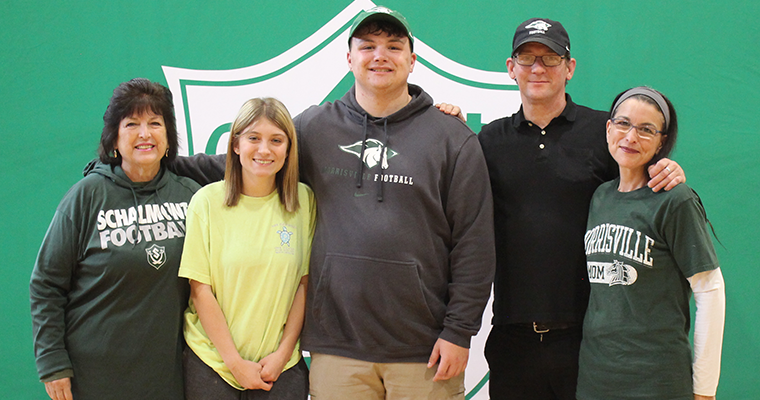 Student athlete poses with their family