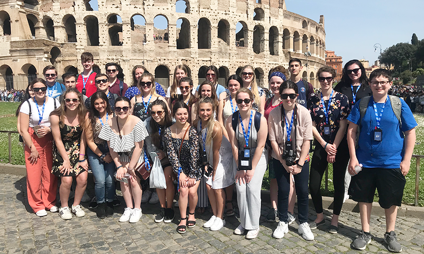 Group photo of students in front of Colliseum
