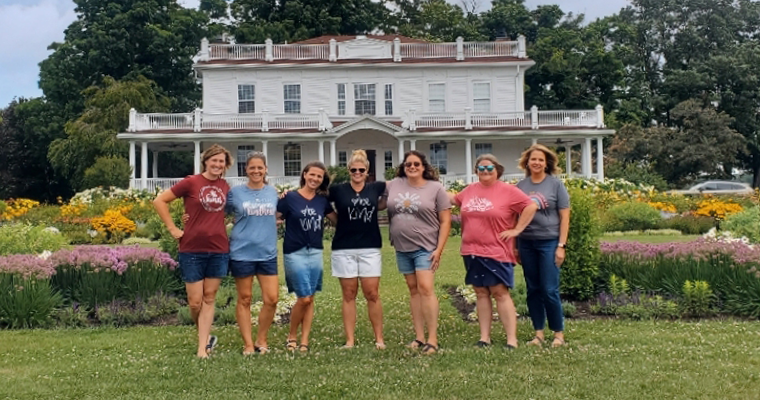 Teacher stand in front of house