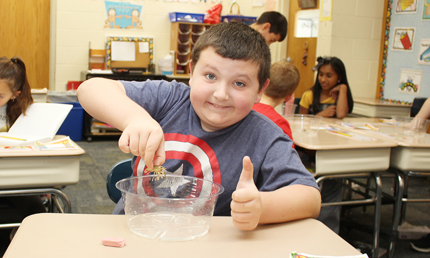 Student holding crayfish