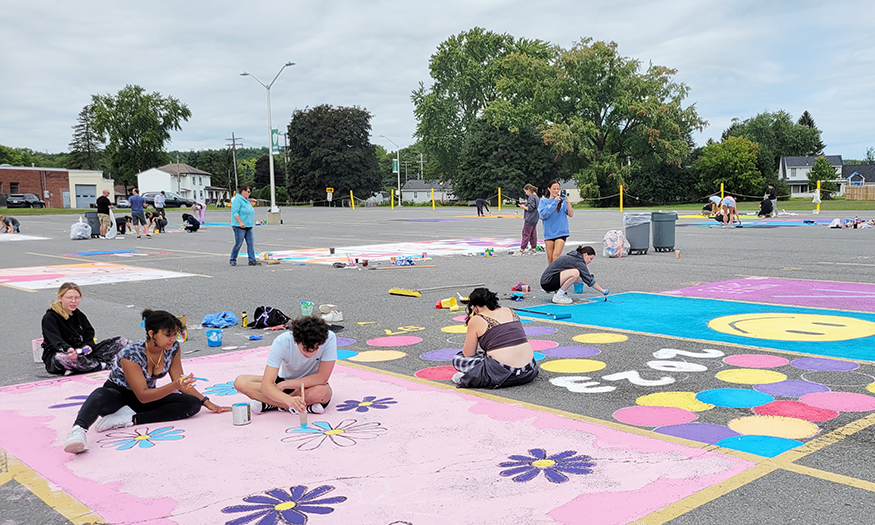 Students paint parking spaces