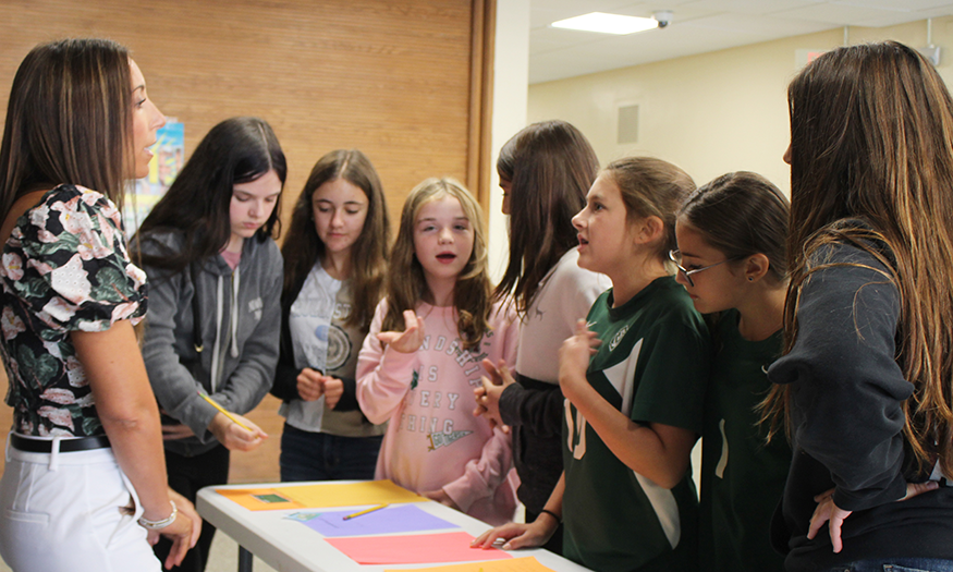 Students gather around sign up table