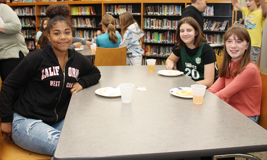 Students pose for photo in library