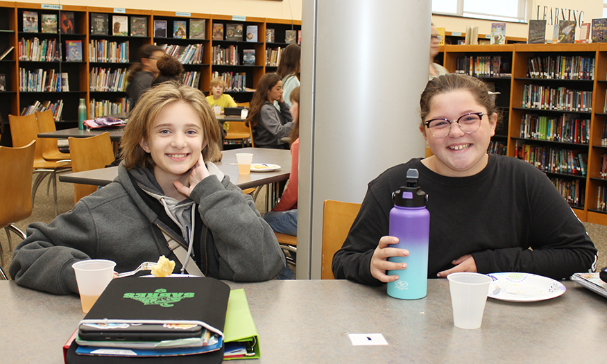 Students pose for photo in library