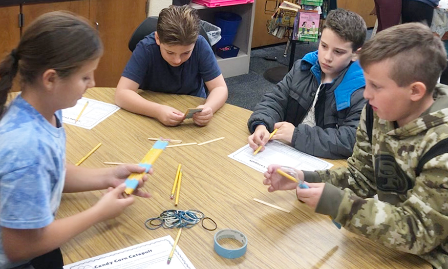 Students plan around a table