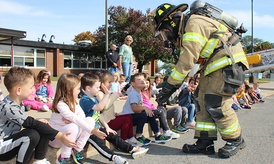 Firefighter with students