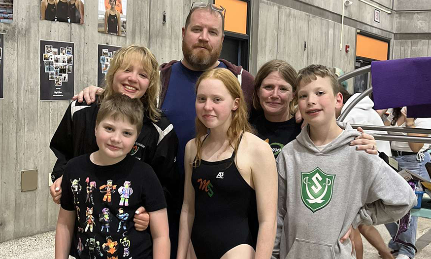 Swimmer and family at Senior Night