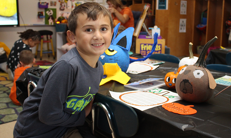 Students with decorated pumpkin