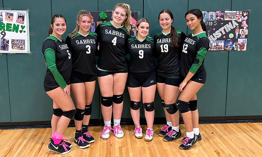 Girl volleyball players pose for group photo