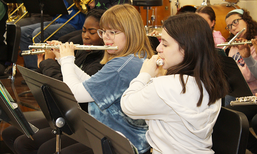 Student musicians play flutes