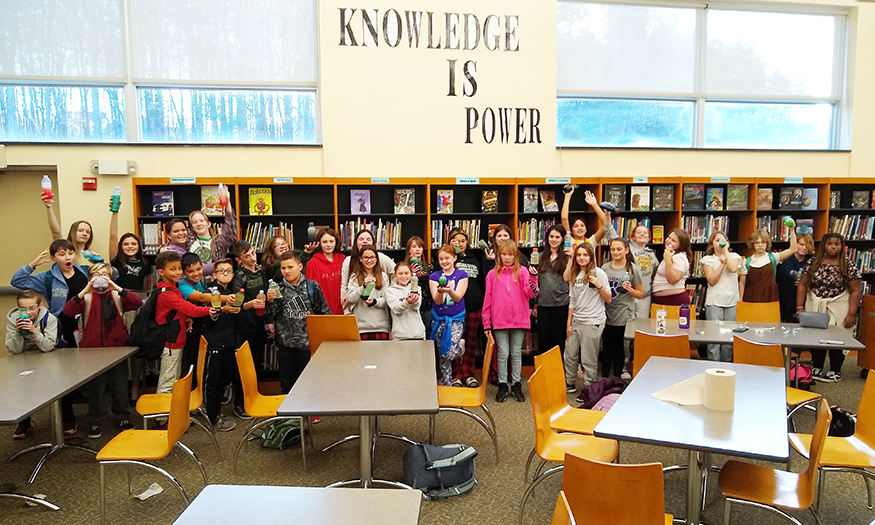 Students pose for group photo in library