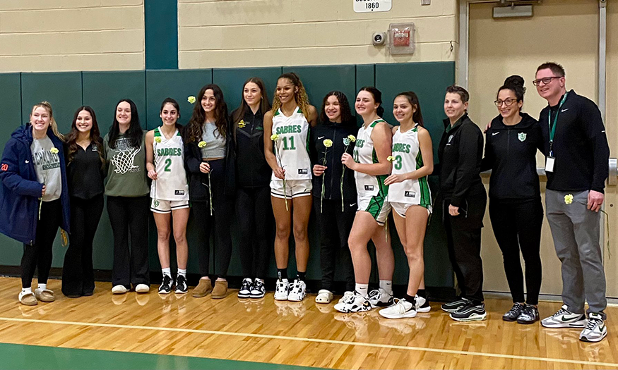 Girls basketball players pose for photo