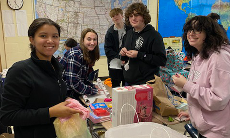 Students wrap presents in classroom
