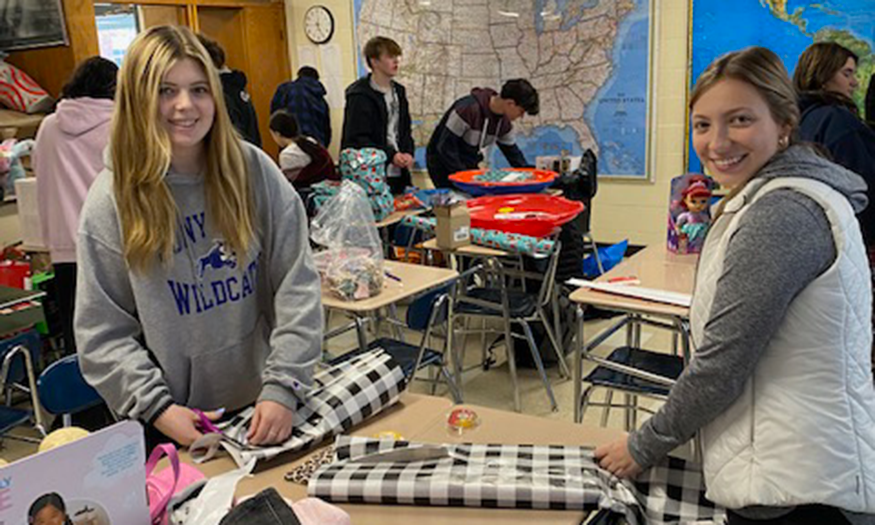 Students wrap presents in classroom