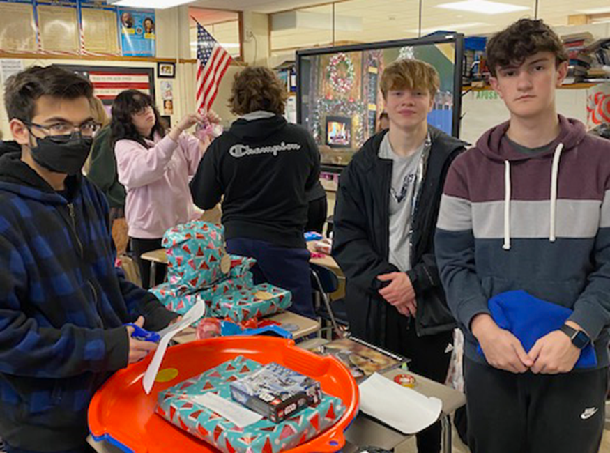 Students wrap presents in classroom