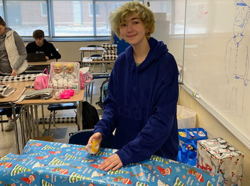 Students wrap presents in classroom