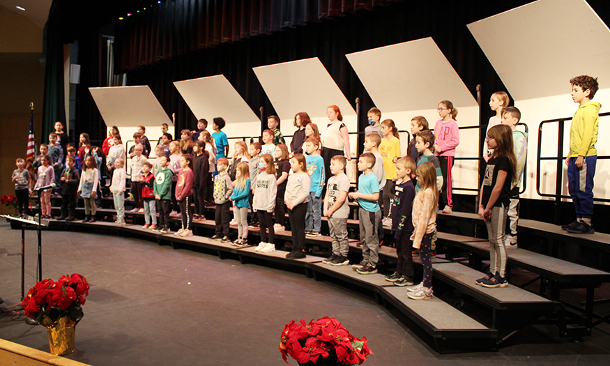 Third graders rehearse for concert on stage