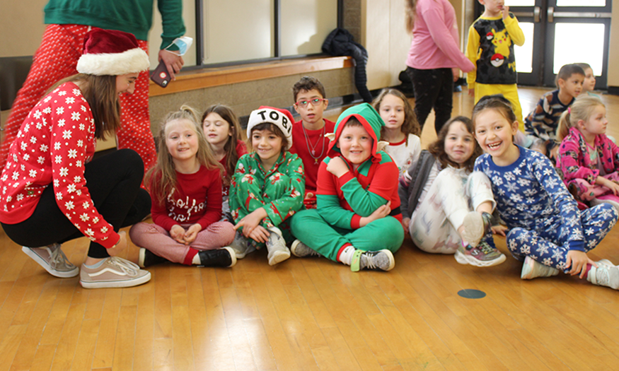 Students smile on gym floor