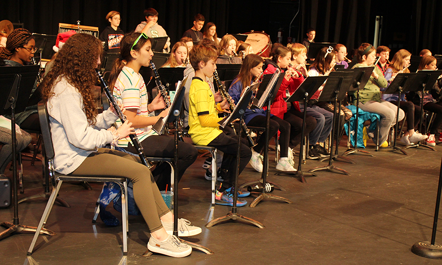 Band students practice on stage