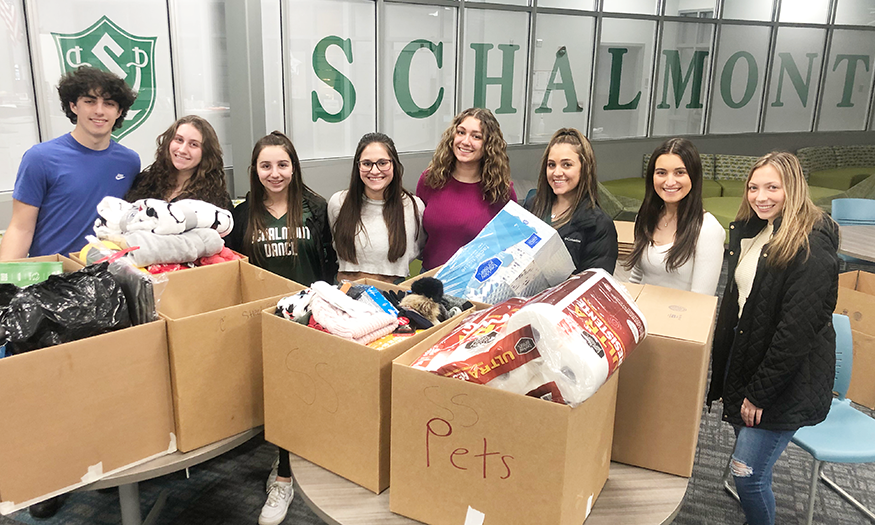 Group photo of students with donation boxes