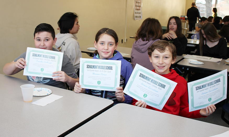 Students pose for photo with awards