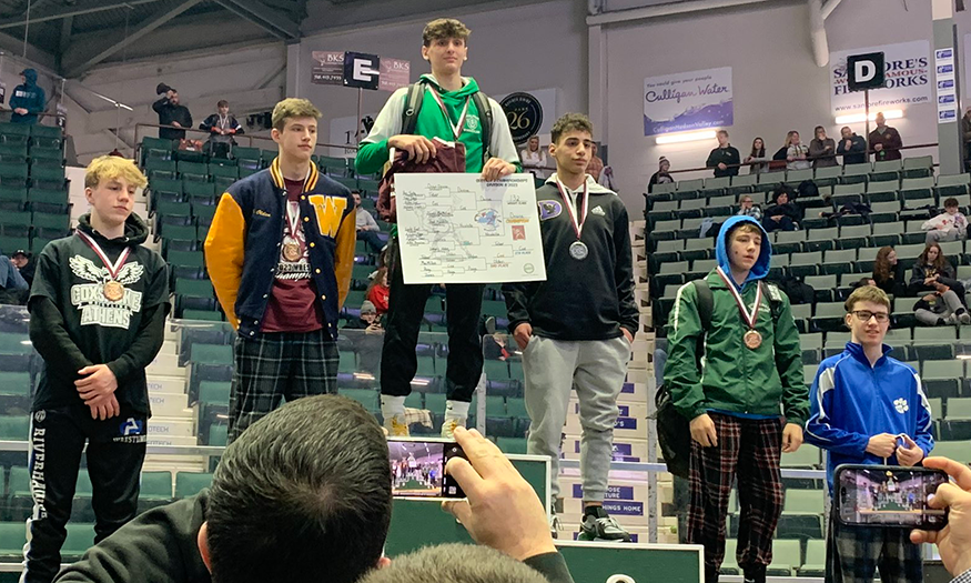 Student on podium with medal