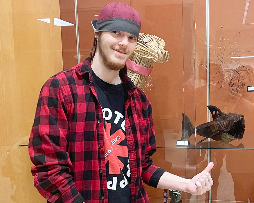 Student pointing at his sculpture