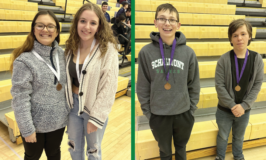 Two pairs of students pose for photo with medals
