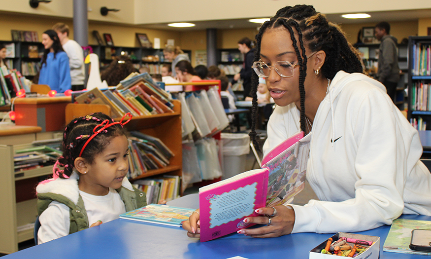 Senior reads to younger student