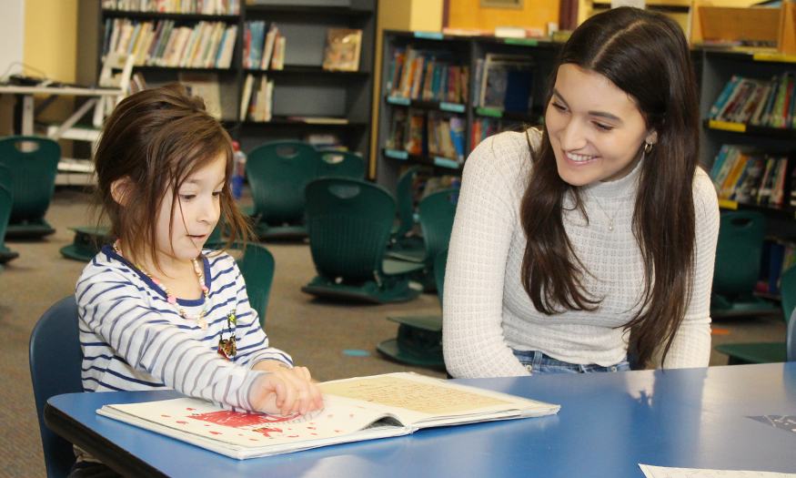 Senior reads to younger student