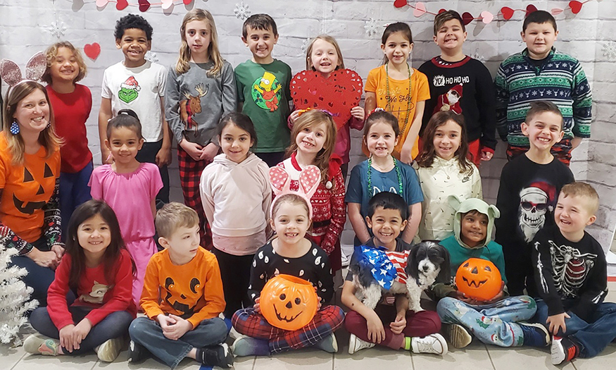 Students pose for photo with holiday-themed clothing