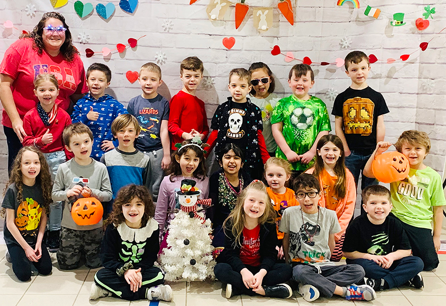 Students pose for photo with holiday-themed clothing