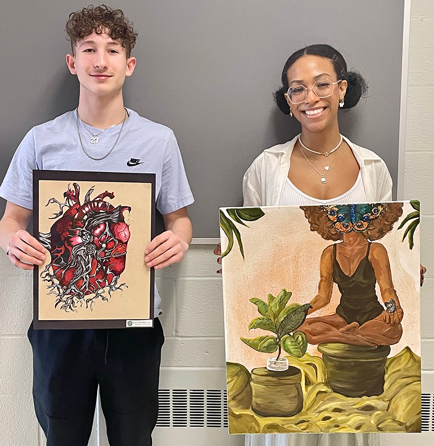 Students holding artwork