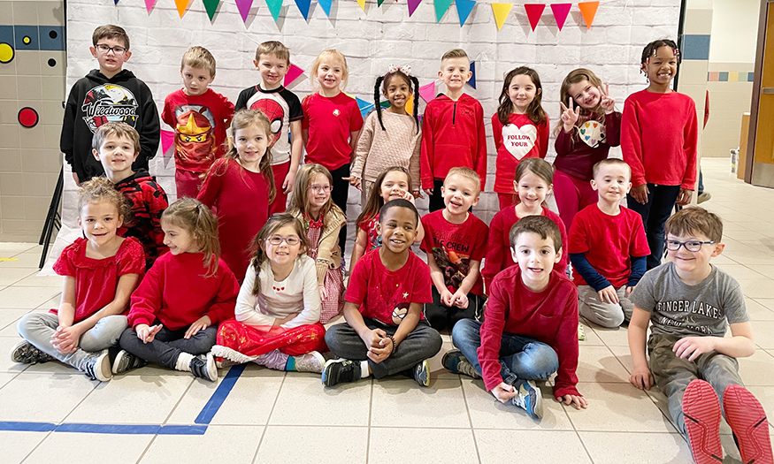 Students pose for photo with red shirts