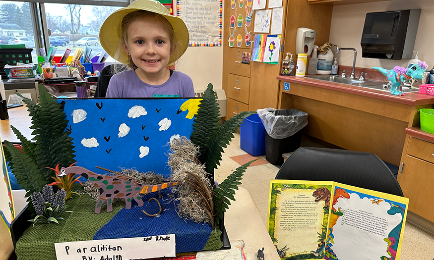 Student with dinosaur project