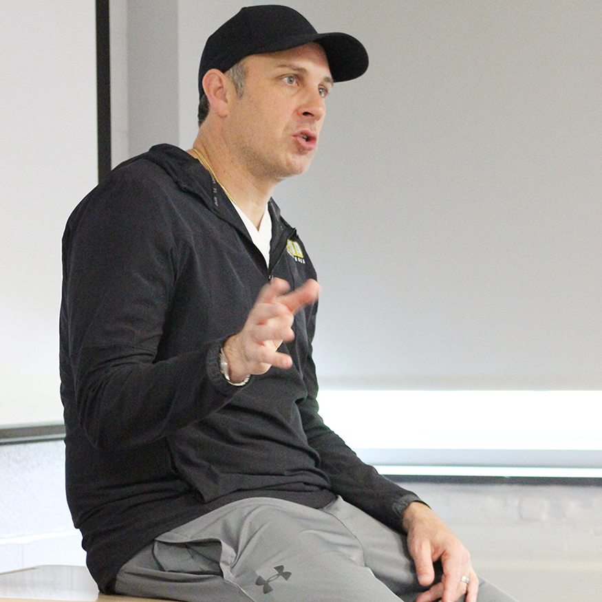 Basketball coach speaks to class