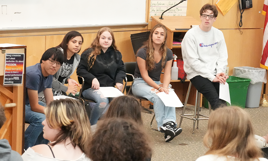 Students listen to questions in a classroom