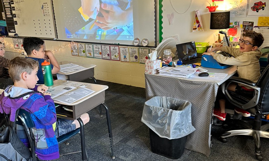 Students teaches at desk