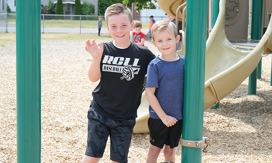 Two young children pose for photo