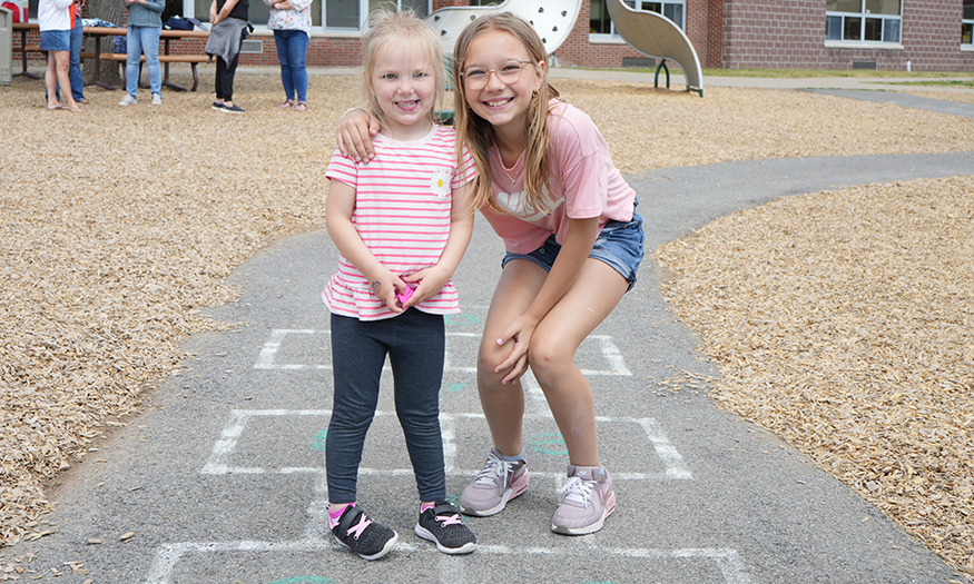 Two young children pose for photo