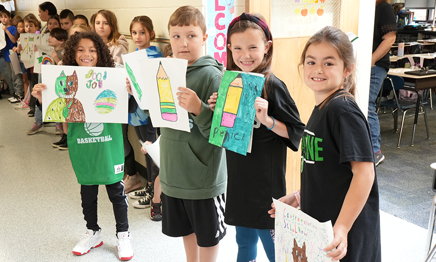 Students with posters in hallway