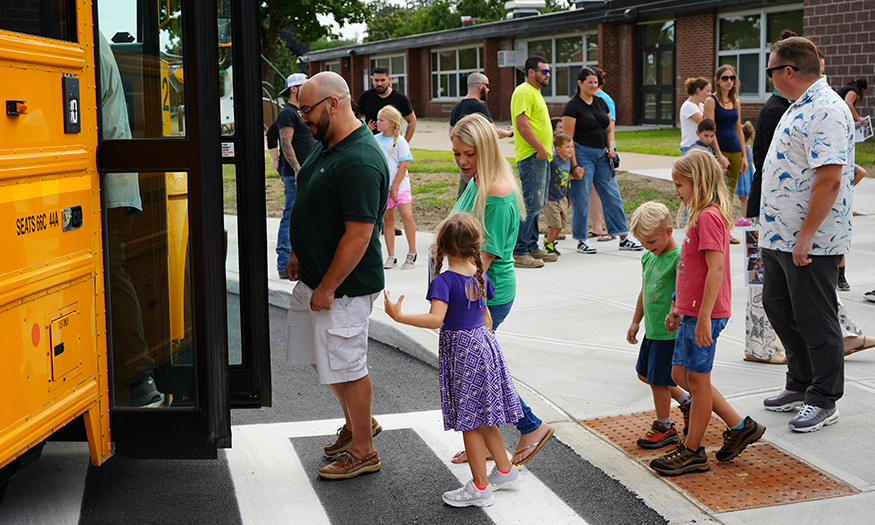 Families line up for school bus