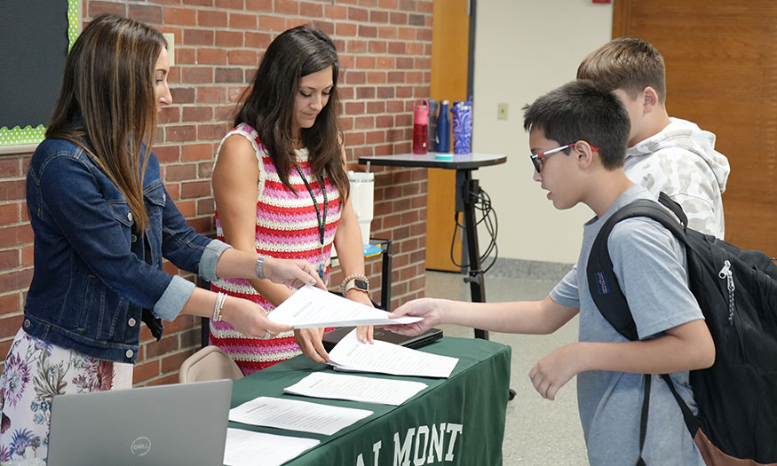 Students receive information at table